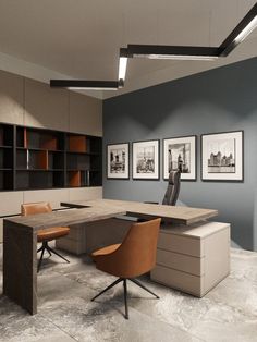 an office with two desks, chairs and pictures on the wall