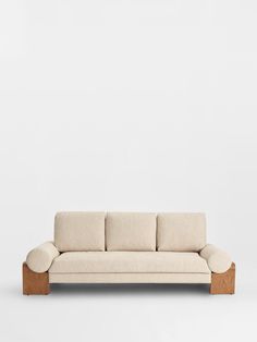 a white couch sitting on top of a wooden frame