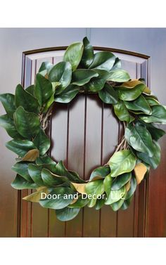 a green wreath hanging on the front door