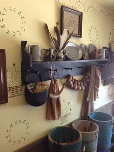 a shelf with pots and pans hanging on it