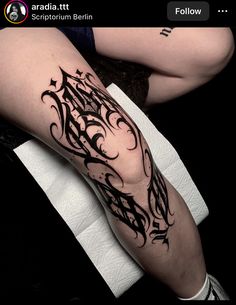 a woman's leg with black ink on it