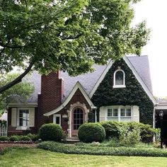 a house with ivy growing all over it's roof and windows in the front yard