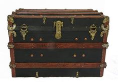 an old trunk with brass handles and locks on the bottom is sitting in front of a white background