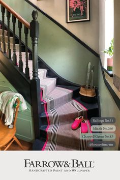 there is a stair case with pink shoes on the bottom and green walls behind it