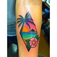 a colorful tattoo with palm trees and flowers on the arm, in front of a beach