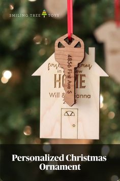 a wooden house ornament hanging from a christmas tree with the words personalized christmas ornaments