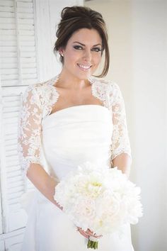 a woman in a wedding dress holding a bouquet