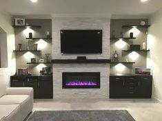 a living room with a fireplace and entertainment center