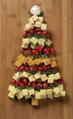 a christmas tree made out of cheese and tomatoes