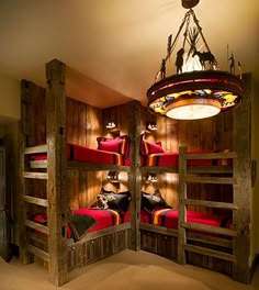 a room with bunk beds made out of wooden pallets and lights hanging from the ceiling