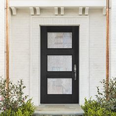 a black front door on a white brick house