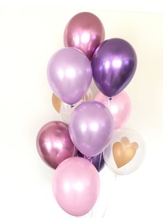 a bunch of balloons that are in the shape of heart shaped balloons with sticks sticking out of them