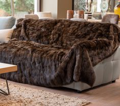 a living room filled with furniture covered in fur