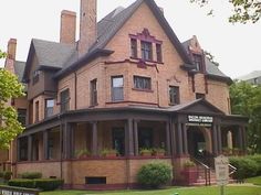 a large brick building with many windows on the top floor and two stories above it