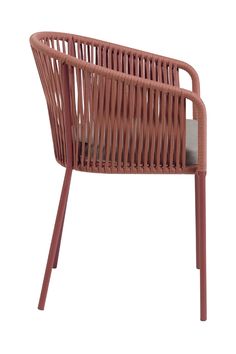 a pink chair that is made out of wicker and has a cushion on it