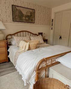 a bedroom with a large bed and wicker baskets