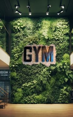 the gym wall is covered with green plants and letters that spell out'gym '