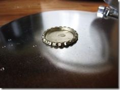 a bottle cap sitting on top of a metal table