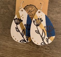 These are hand-painted, wood earrings. They have flowers and geometric patterns on them. They sit on silver plated fish hooks. There are plastic earrings on each one. Hand Painted Earrings Wood, Painted Bookmarks, Laser Jewelry, Wood Journal, Laser Cut Wood Earrings, Watercolor On Wood, Hand Painted Earrings, Sale Ideas, Plastic Earrings