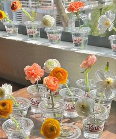 there are many glass vases with flowers in them