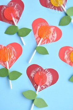 candy lollipops in the shape of hearts on a blue background