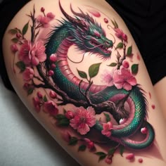 a woman's thigh with flowers and a dragon on it