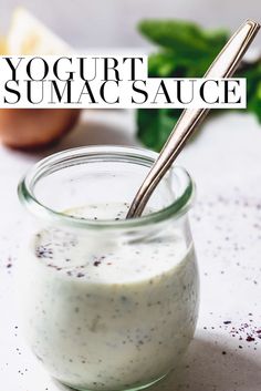 yogurt sauce in a small glass jar with a silver spoon on the side