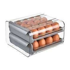 an egg tray with six eggs in it and two separate sections on the top shelf