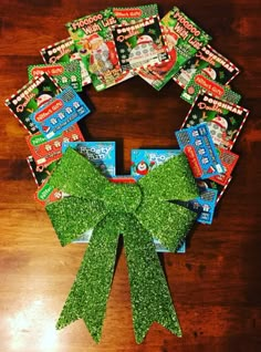 a wreath made out of gummy bears on top of a wooden table with green bow