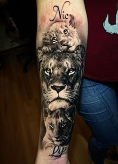 a woman's arm with a lion and lions tattoo on the left side of her arm