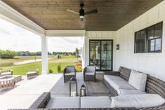 a covered porch with couches and tables on it