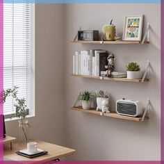 three wooden shelves on the wall above a desk with a laptop and other office supplies