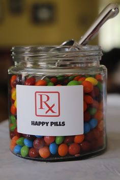 a jar filled with lots of candy sitting on top of a table