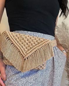 a woman is wearing a skirt made out of jute and woven material with an intricate design on the side