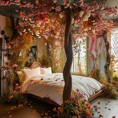 a bed with lots of flowers on it and a canopy over the bed in front