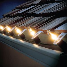 five lights are on the edge of a desk with papers in the background