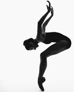 a black and white photo of a ballerina