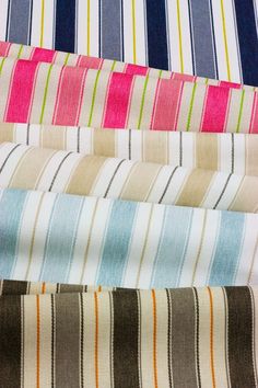 four different colored striped fabrics are lined up