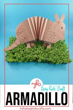 an origami armadillo is sitting on top of some green grass with the text easy kids craft armadillo