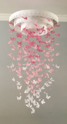 a chandelier with pink and white butterflies hanging from it