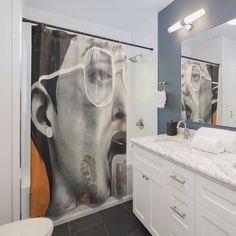 a bathroom with a large shower curtain in the middle and a painting on the wall