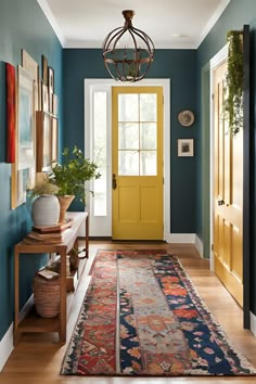 an entryway with blue walls and yellow door, rugs on the floor and potted plants