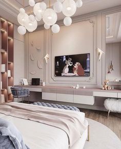 a bedroom with a large television mounted to the wall