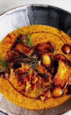 a bowl filled with food and garnished with some sprigs on top