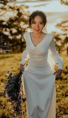 a woman in a white dress holding flowers