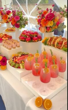 there are many different types of food on the table and in vases with flowers