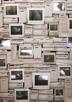 there are many old televisions stacked on top of each other in the wall together