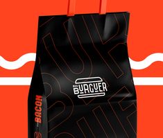 a black paper bag with the word suppuer on it and an orange background