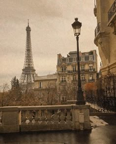 the eiffel tower is seen from across the street in paris, france on a rainy day