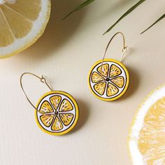 These vibrant citrus slice hoops will add a zesty flair to outfits and make a great summertime statement! These original earrings are hand painted on cherry wood and feature etched details and hand-painting in your choice of orange or lemon. The hoops connect through the center of the orange which creates a fun kinetic spinning motion like a pinwheel. Lightweight and cute, these detailed earrings are a fun addition to your wardrobe and make a great gift!Color options 🌈: 🍊 Orange 🍋 Lemon Option 1: Gold HoopsThese earrings feature 30mm 316 surgical stainless steel gold hoops with a simple hook closure.Option 2: Silver HoopsThese earrings feature 30mm 925 sterling silver-plated, nickel-free and lead-free brass hoops with a simple round loop and hook closure. Citrus Slice, Brass Hoops, Hand Painting, Gift Card Shop, Orange Gold, Gold Hoops, Cherry Wood, Gift Necklace, Jewelry Shop